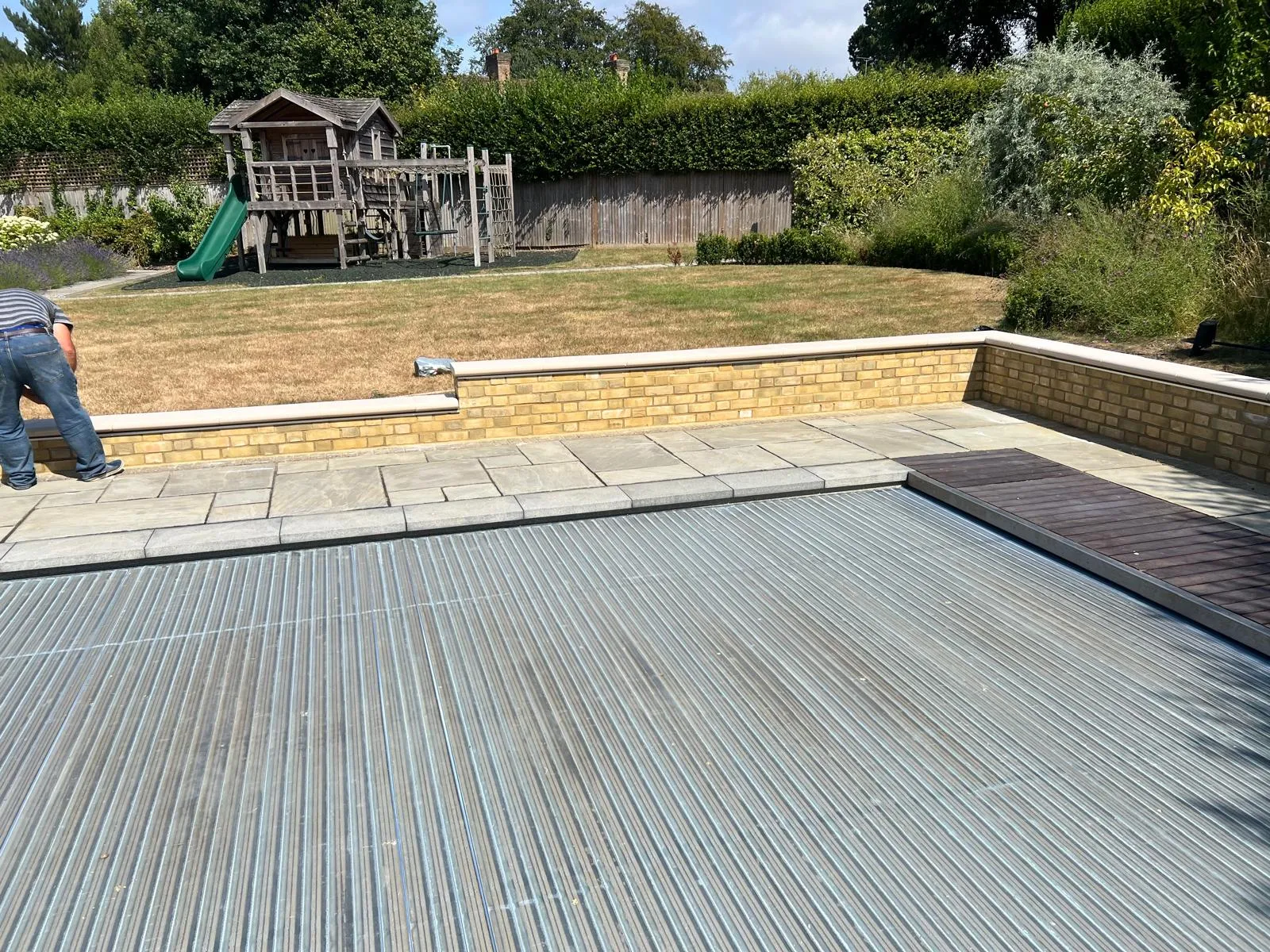 Pool terrace: Sandstone terrace and a hardwood decking strip wrapping the pool.