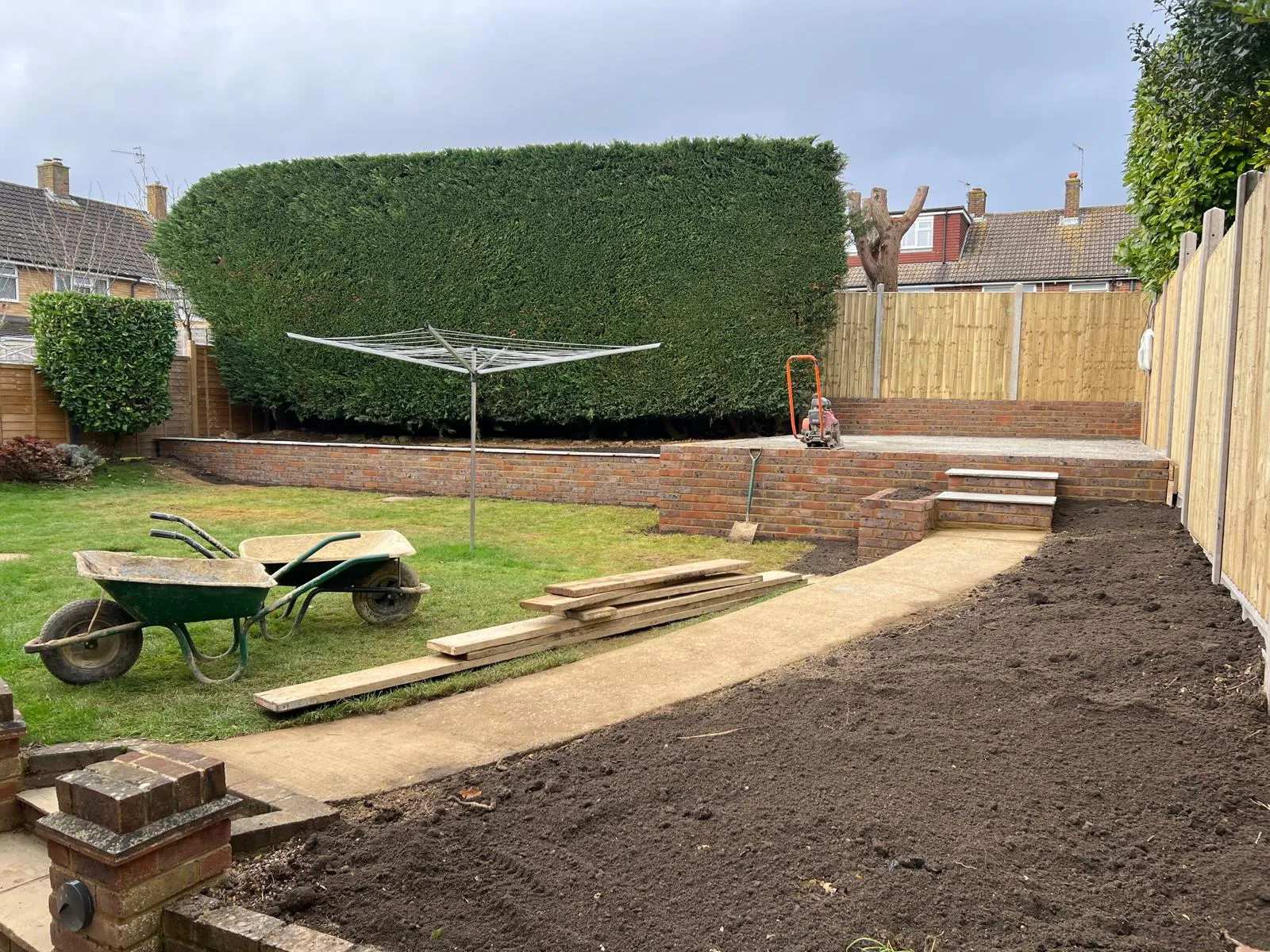 Mid-build: brick walls and steps in, the top bed dug over.