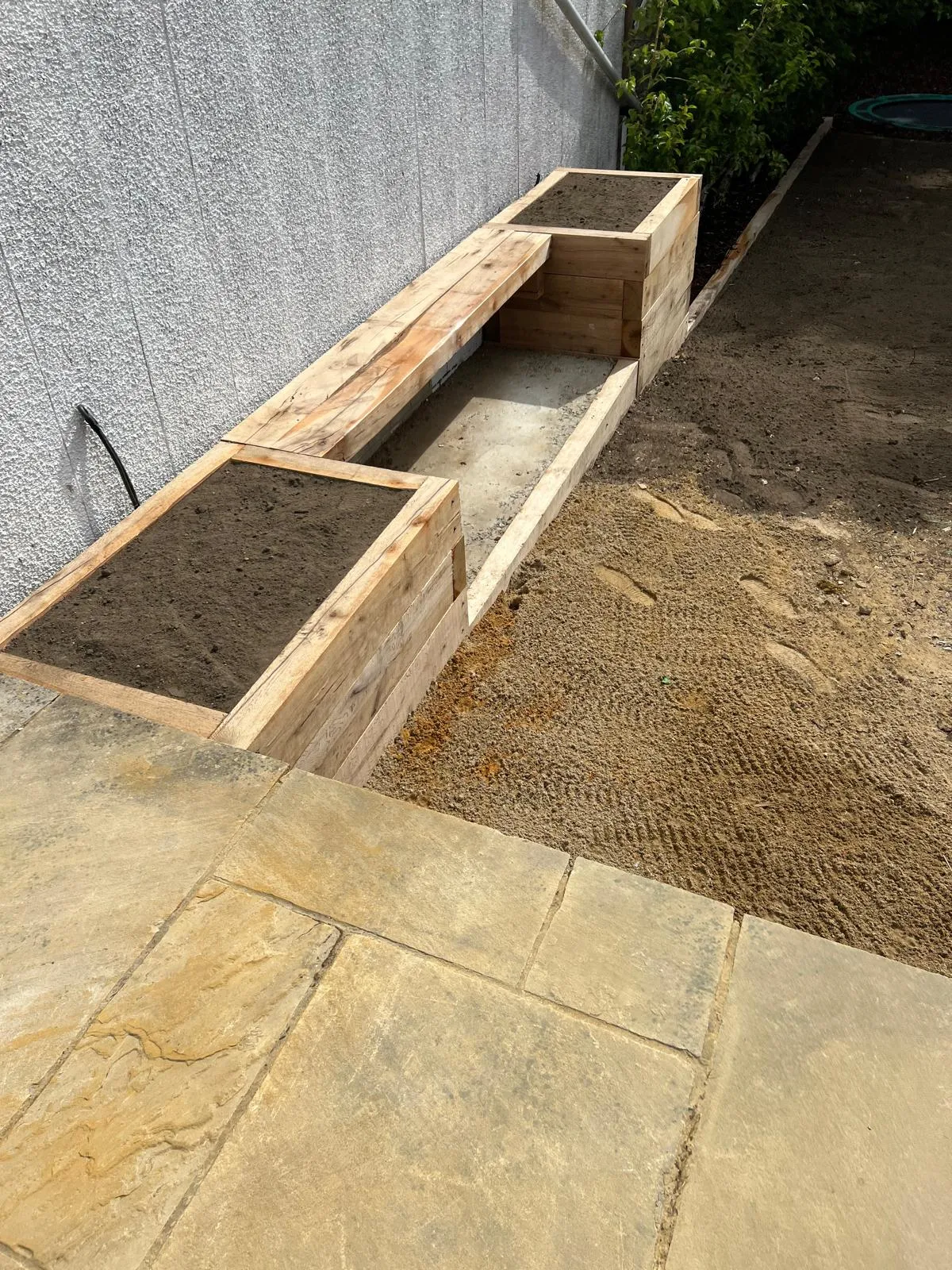 Sleeper beds built and the sand base going down against the new sandstone.